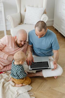 Same sex couple playing with a child